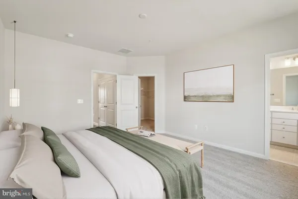 a bedroom with a bed and a painting on the wall