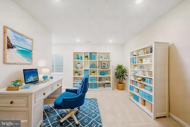 a living room with furniture and a bookshelf
