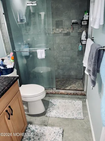 a bathroom with a toilet and a shower