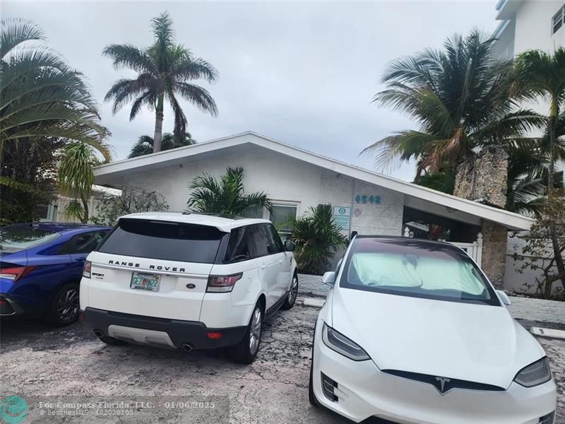 4548 North Ocean Drive, Unit 4 Lauderdale-by-the-Sea, FL 33308 - Photo 47 of 48 a car parked in front of white house