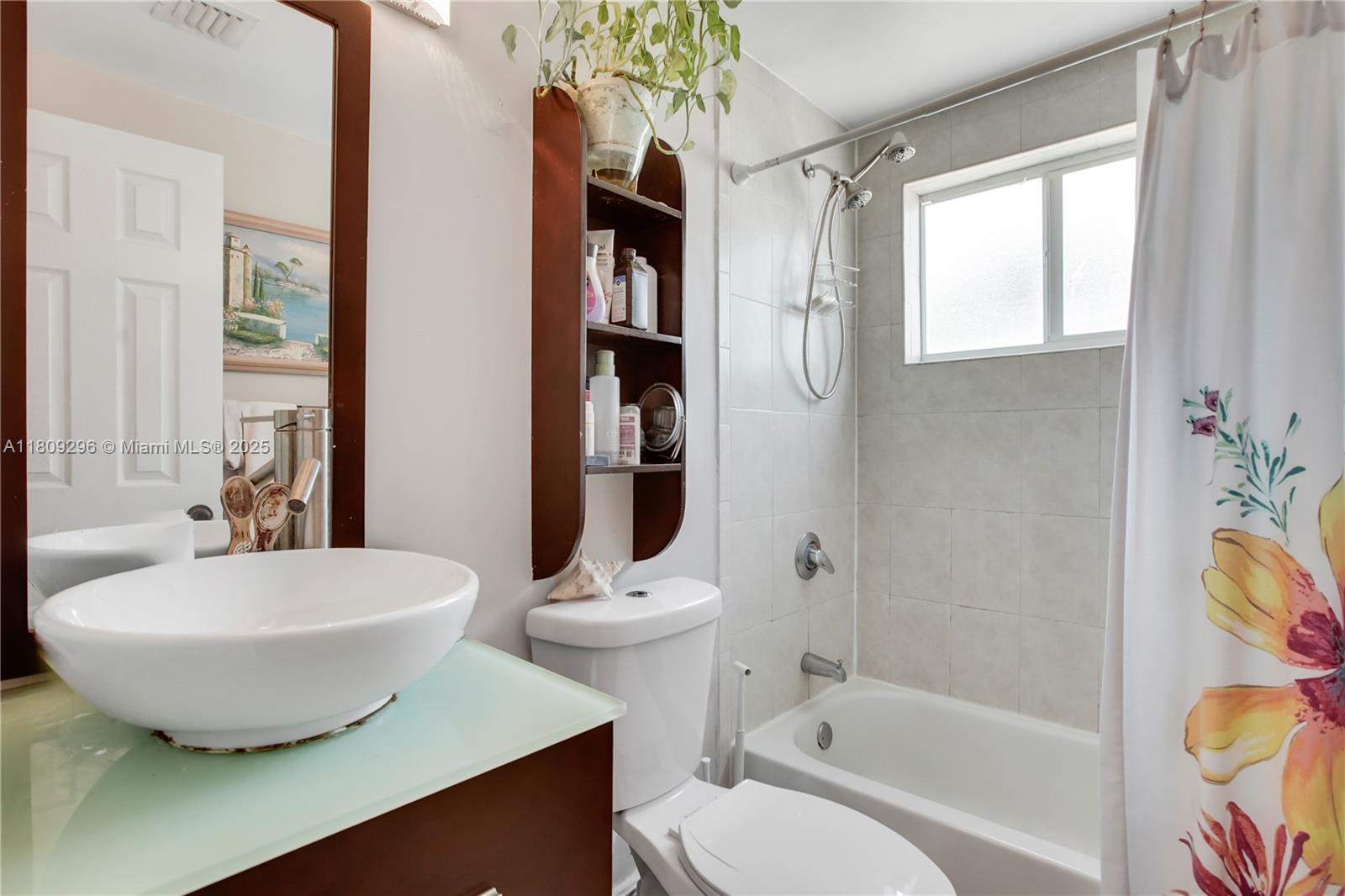 3101 Southwest 27th Avenue, Unit 203 Miami, FL 33133 - Photo 12 of 25 a bathroom with a bathtub sink and toilet