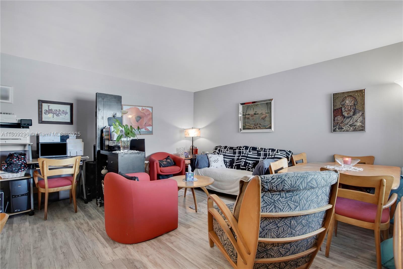 3101 Southwest 27th Avenue, Unit 203 Miami, FL 33133 - Photo 2 of 25 a living room with furniture and a flat screen tv