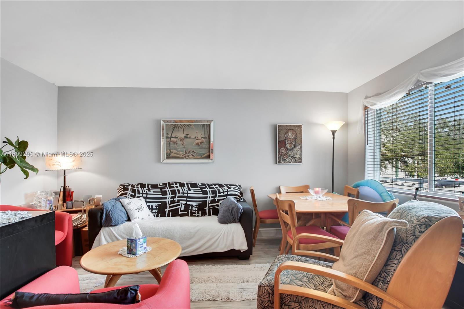 3101 Southwest 27th Avenue, Unit 203 Miami, FL 33133 - Photo 5 of 25 a living room with furniture and a large window