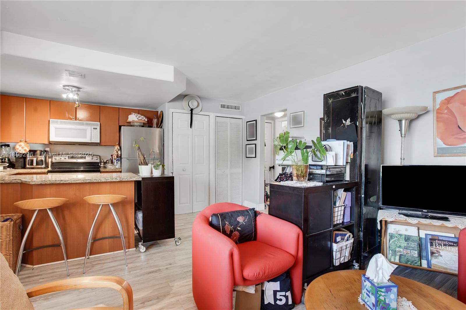 3101 Southwest 27th Avenue, Unit 203 Miami, FL 33133 - Photo 8 of 25 a living room with furniture and a flat screen tv