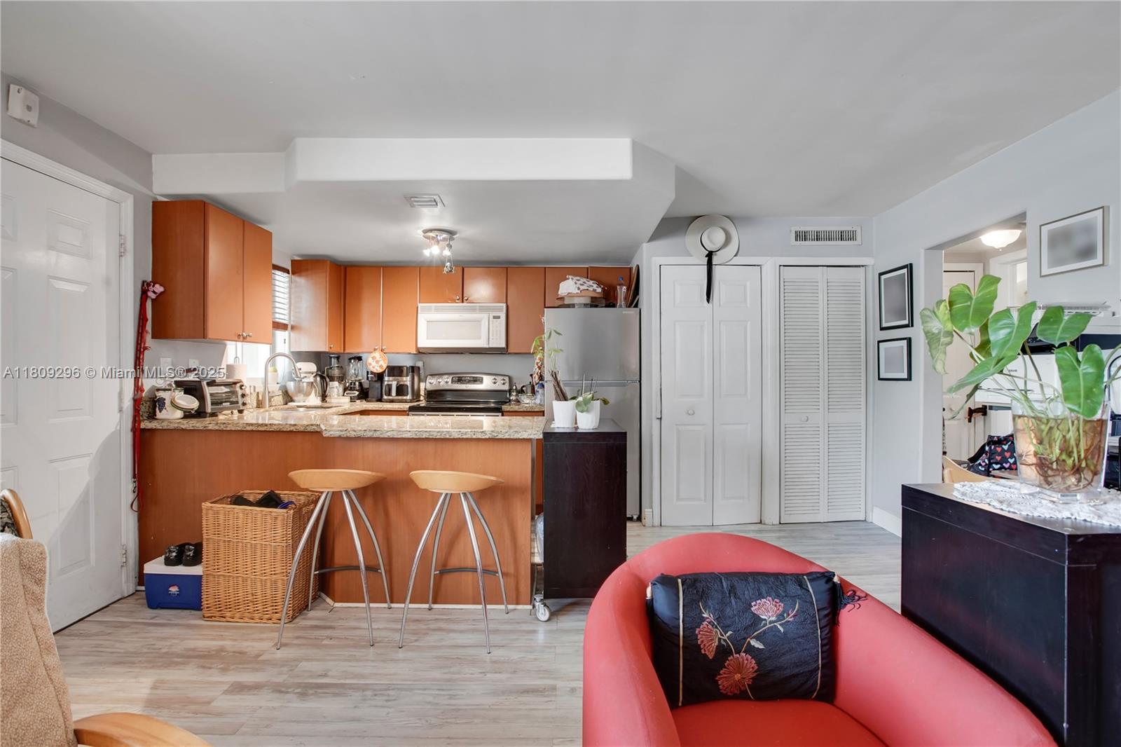 3101 Southwest 27th Avenue, Unit 203 Miami, FL 33133 - Photo 9 of 25 a living room with stainless steel appliances granite countertop furniture and a kitchen view