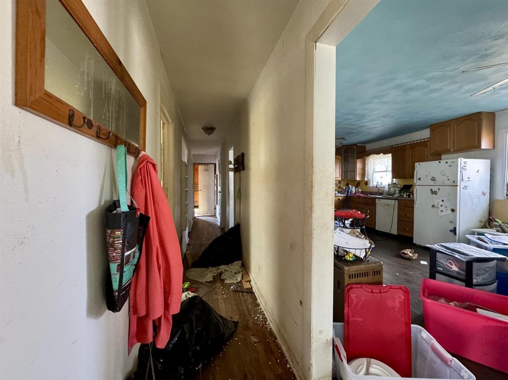 613 West Main Street Crowley, TX 76036 - Photo 18 of 30 Hallway with dark wood-style flooring and baseboards