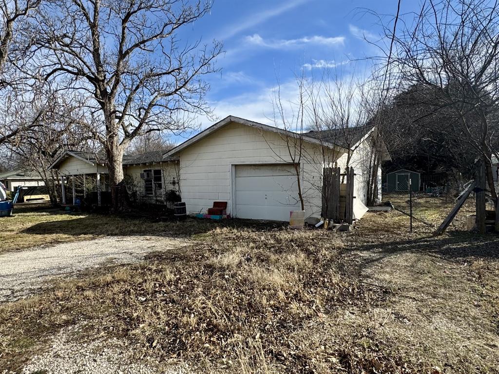 613 West Main Street Crowley, TX 76036 - Photo 23 of 30 View of home's exterior with an attached garage and driveway