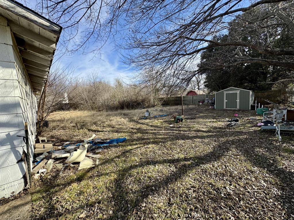 613 West Main Street Crowley, TX 76036 - Photo 24 of 30 View of backyard with a storage shed