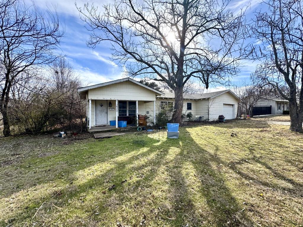 613 West Main Street Crowley, TX 76036 - Photo 3 of 30 Back of property featuring covered porch, a yard, and a garage
