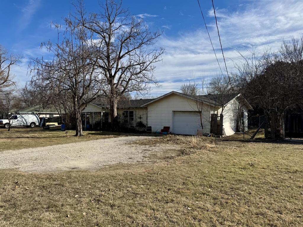 613 West Main Street Crowley, TX 76036 - Photo 4 of 30 Single story home with a garage, dirt driveway, and a front yard