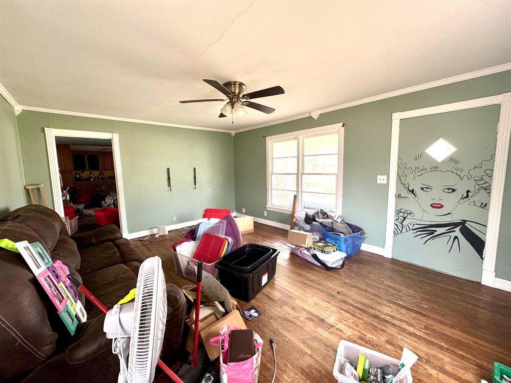 613 West Main Street Crowley, TX 76036 - Photo 6 of 30 Living room with wood finished floors, ceiling fan, and ornamental molding
