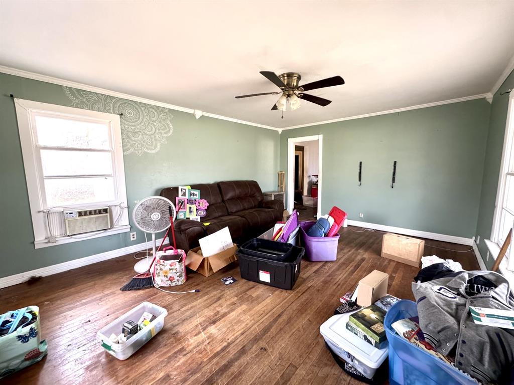 613 West Main Street Crowley, TX 76036 - Photo 7 of 30 Living room featuring hardwood / wood-style floors, crown molding, and ceiling fan