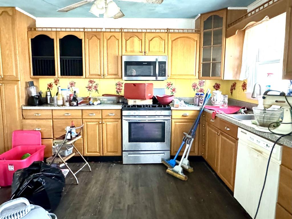 613 West Main Street Crowley, TX 76036 - Photo 10 of 30 Eat-In Kitchen has NEW Cabinets and Gas stainless steel appliances, dark wood-type flooring, and light countertops with built-in pantry and dishwasher.