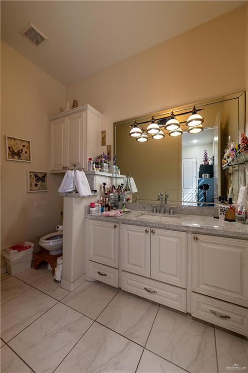 3801 South L Street McAllen, TX 78503 - Photo 14 of 38 a view of a double sink and chair in a room