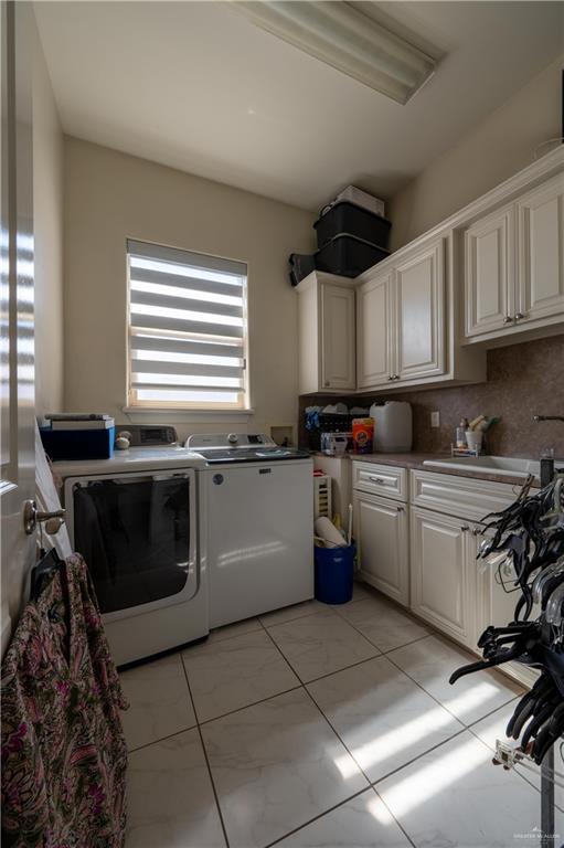 3801 South L Street McAllen, TX 78503 - Photo 23 of 38 a kitchen with a stove a sink and a microwave