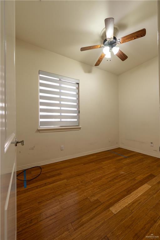 3801 South L Street McAllen, TX 78503 - Photo 24 of 38 a view of an empty room with wooden floor and a window