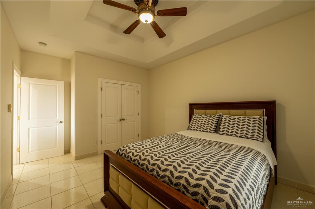 3801 South L Street McAllen, TX 78503 - Photo 29 of 38 a bedroom with a bed and a chandelier
