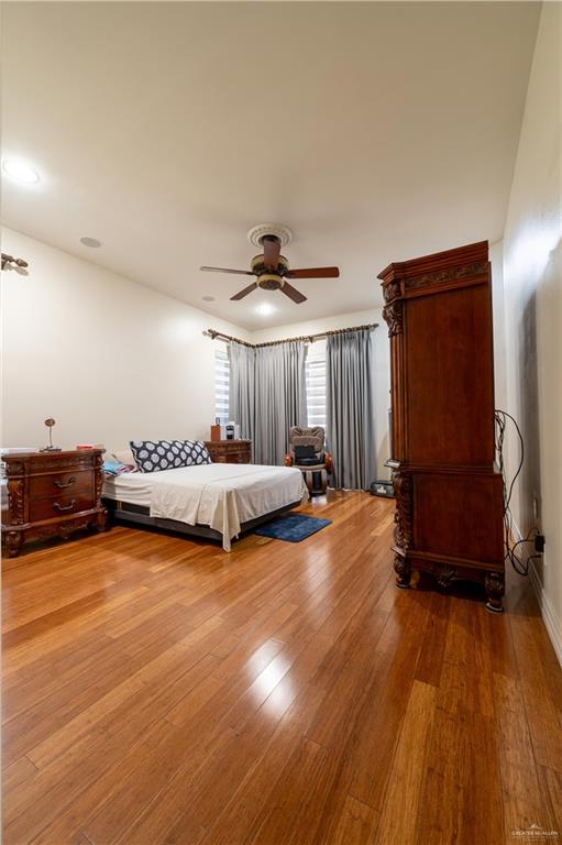 3801 South L Street McAllen, TX 78503 - Photo 7 of 38 a view of a bedroom with furniture wooden floor and window