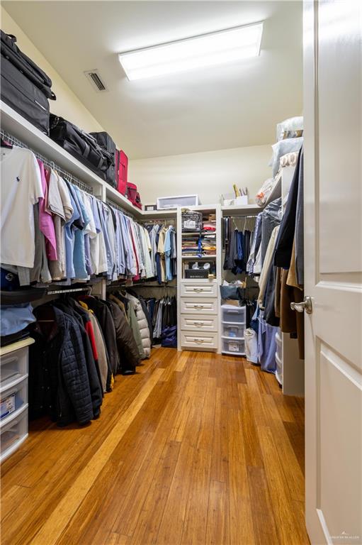 3801 South L Street McAllen, TX 78503 - Photo 9 of 38 a view of walk in closet with clothes and shoes