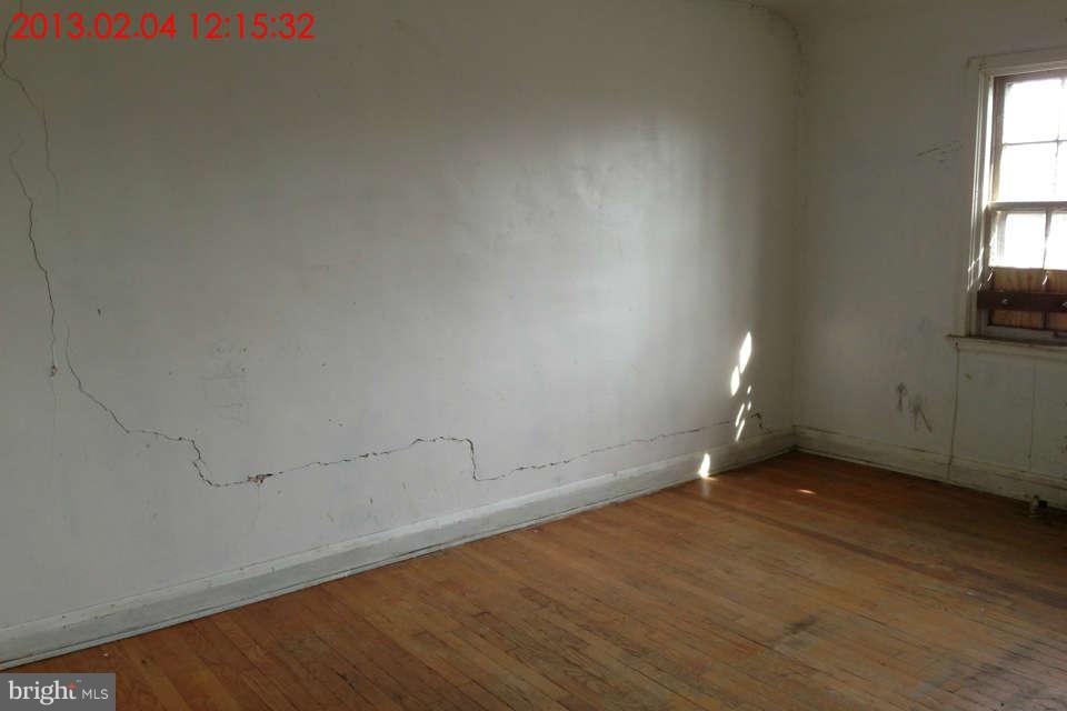 5417 Lothian Road Baltimore, MD 21212 - Photo 4 of 9 an empty room with wooden floor and windows