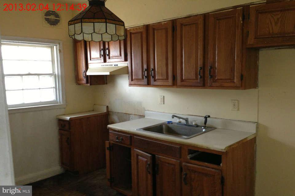 5417 Lothian Road Baltimore, MD 21212 - Photo 6 of 9 a kitchen with a sink cabinets and window