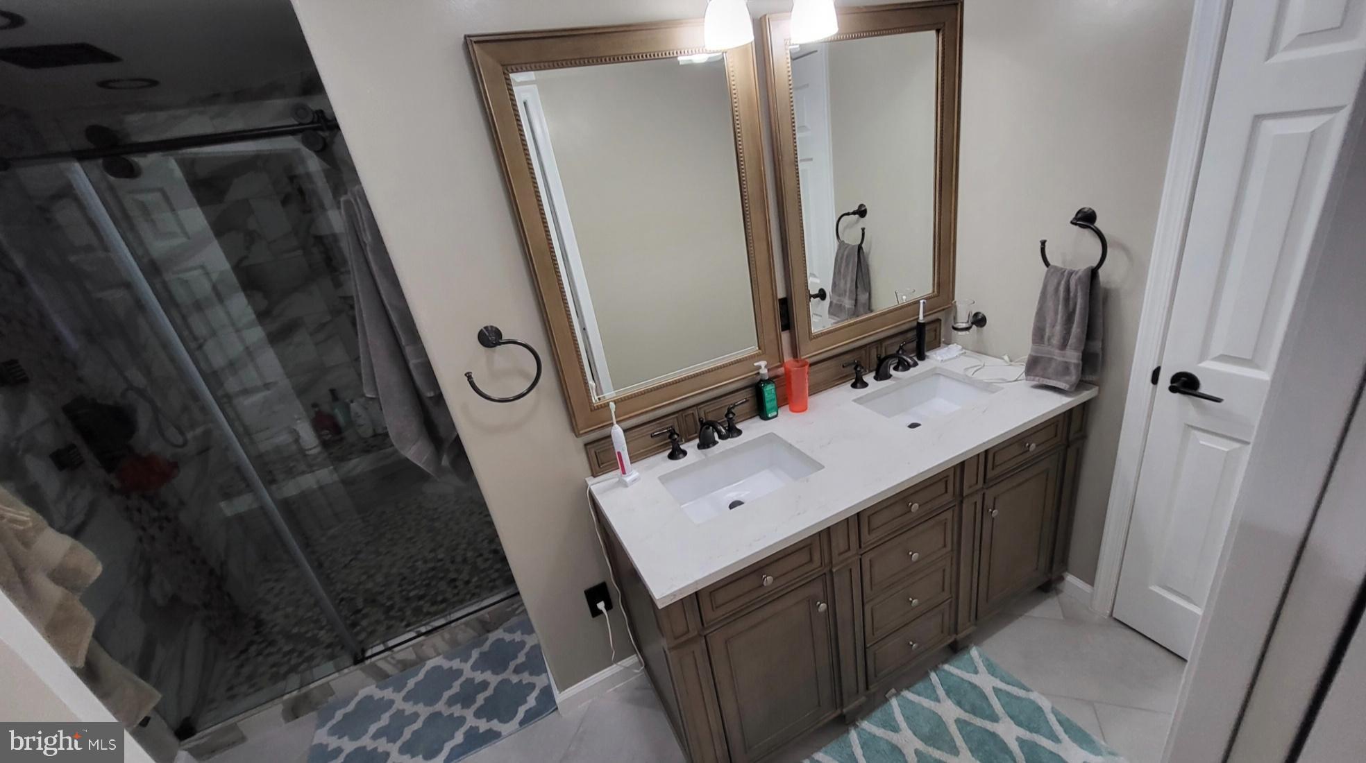 8001 Postoak Road Potomac, MD 20854 - Photo 16 of 30 a bathroom with a sink vanity mirror and toilet