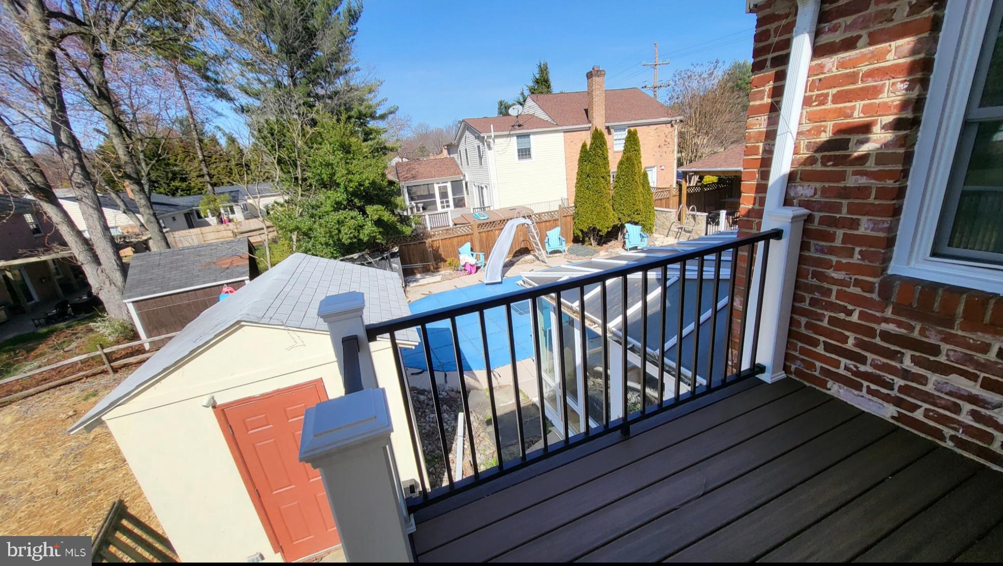 8001 Postoak Road Potomac, MD 20854 - Photo 20 of 30 a view of a balcony with wooden floor and furniture