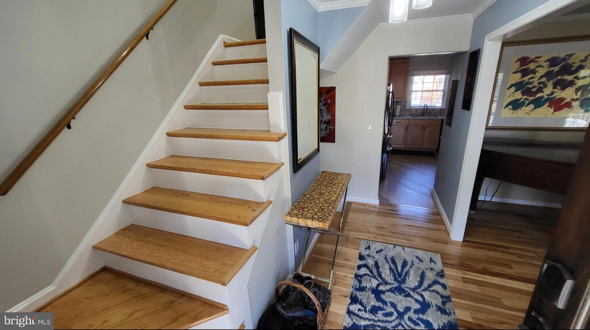 8001 Postoak Road Potomac, MD 20854 - Photo 25 of 30 a view of staircase with lots of frames on wall and a window