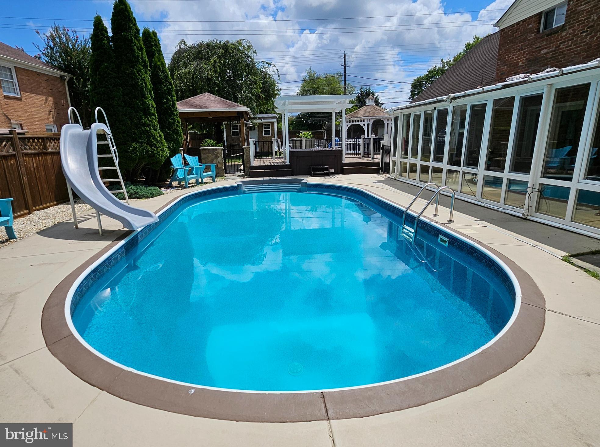 8001 Postoak Road Potomac, MD 20854 - Photo 4 of 30 a view of swimming pool with outdoor seating