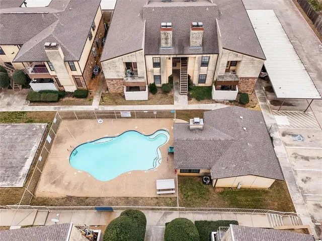 an aerial view of residential houses with outdoor space