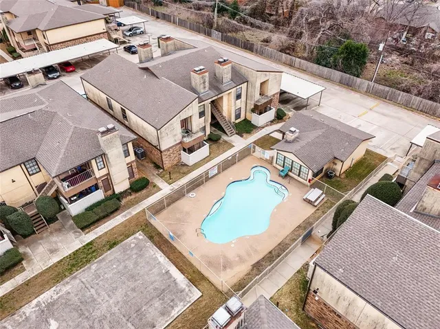 an aerial view of residential houses with outdoor space