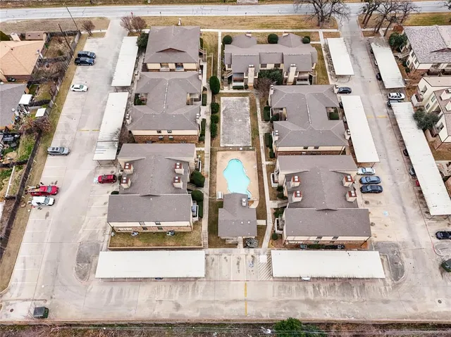 an aerial view of residential houses with outdoor space