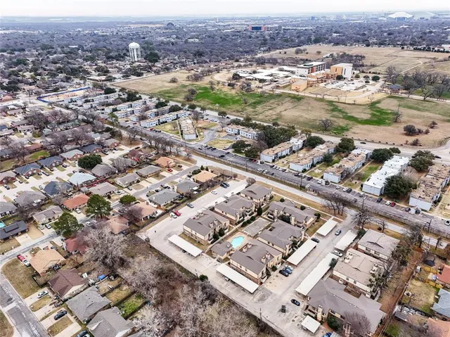 an aerial view of residential houses with outdoor space
