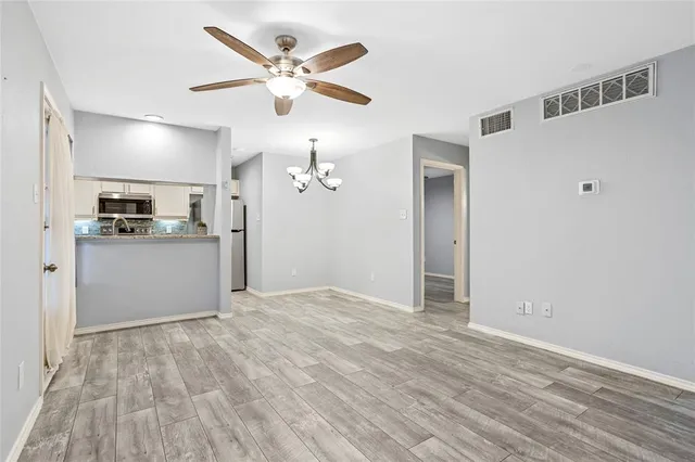 a view of a kitchen with a sink hardwood floor and a ceiling fan