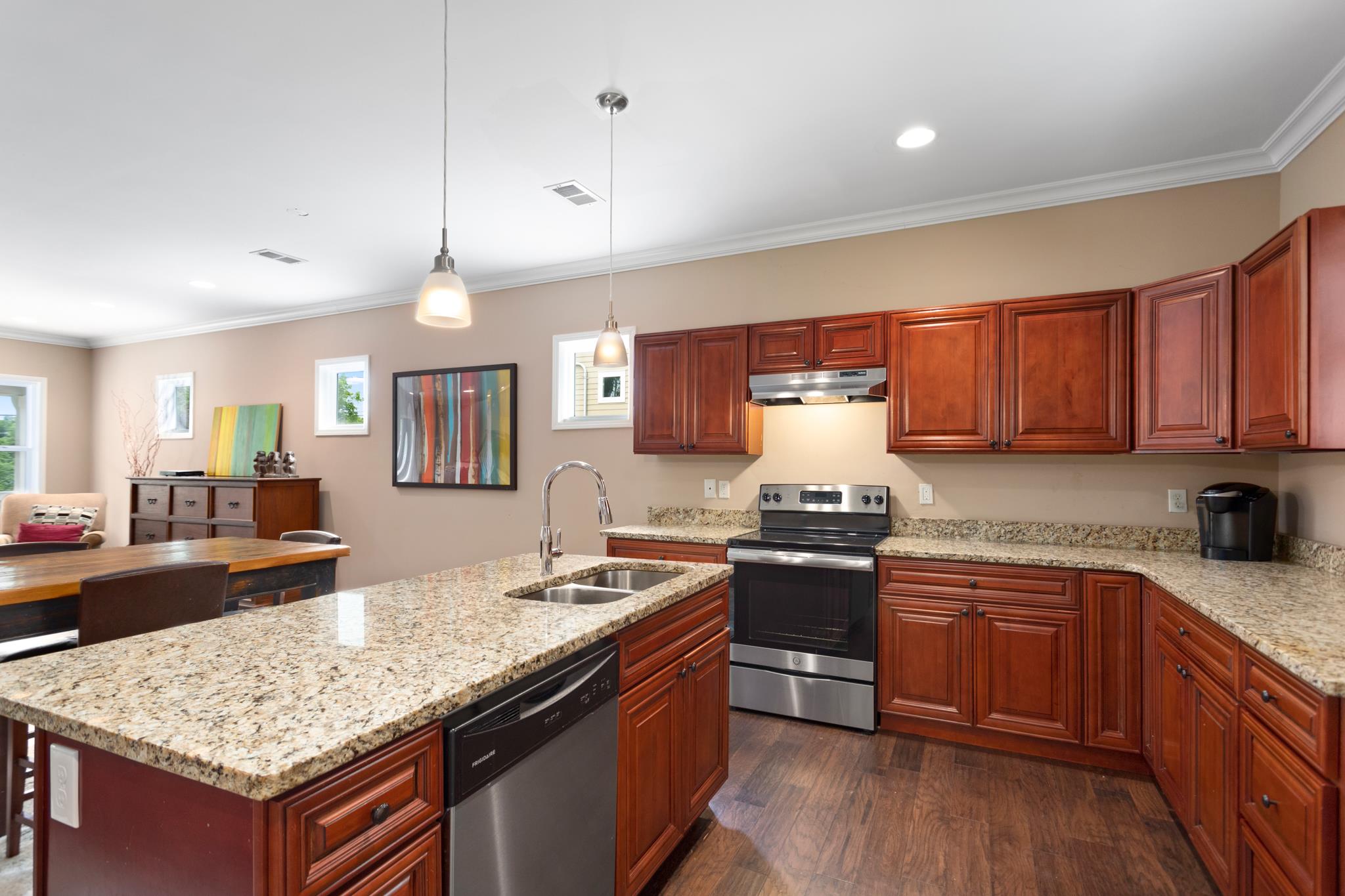 353 Flora Maxwell Road Nashville, TN 37211 - Photo 5 of 14 The kitchen also has stainless steel appliances and sink, soft close "tongue & groove" cabinetry, granite countertops and pendant lighting above the island.