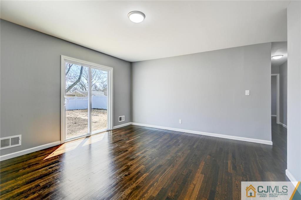 30 Purdue Road Old Bridge, NJ 08859 - Photo 11 of 25 an empty room with wooden floor and windows
