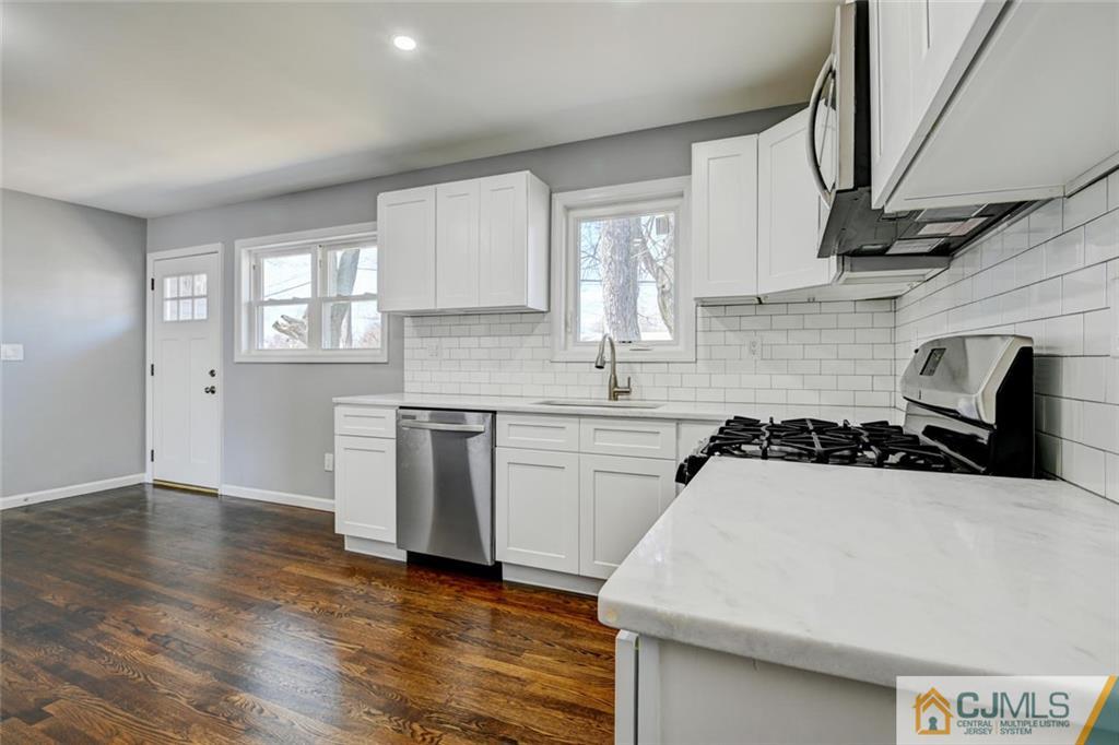 30 Purdue Road Old Bridge, NJ 08859 - Photo 5 of 25 a kitchen with a sink a stove and cabinets