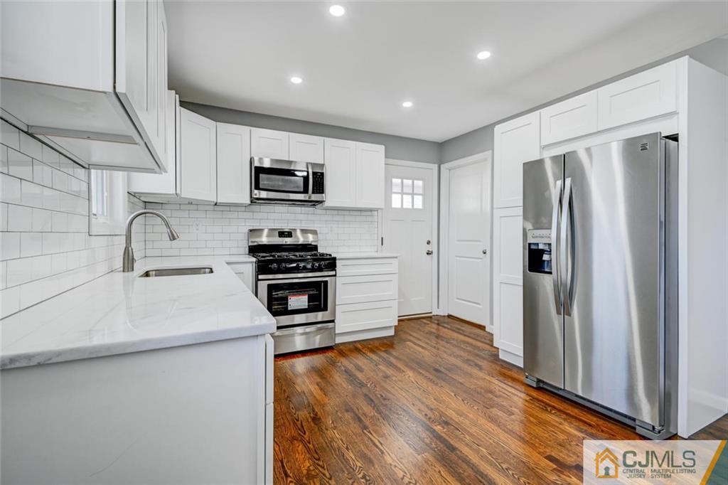 30 Purdue Road Old Bridge, NJ 08859 - Photo 6 of 25 a kitchen with stainless steel appliances a refrigerator sink and microwave