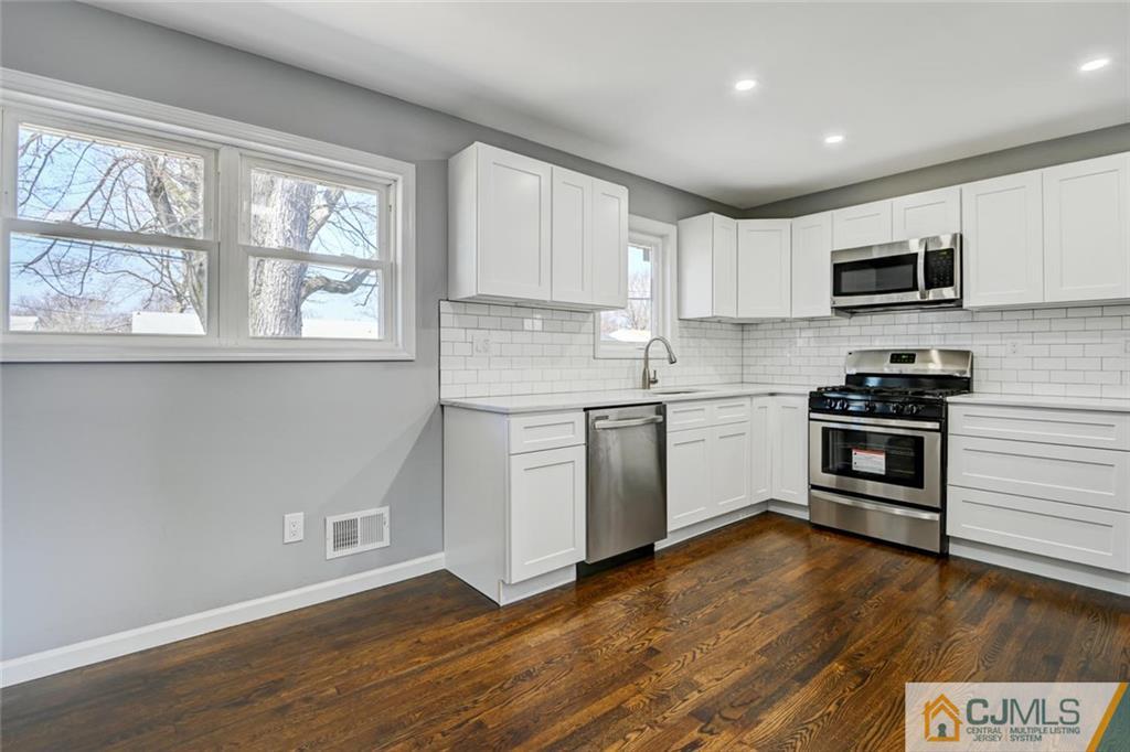 30 Purdue Road Old Bridge, NJ 08859 - Photo 7 of 25 a kitchen with a sink a window and stainless steel appliances