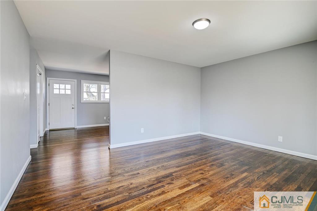 30 Purdue Road Old Bridge, NJ 08859 - Photo 9 of 25 a view of an empty room with window and wooden floor