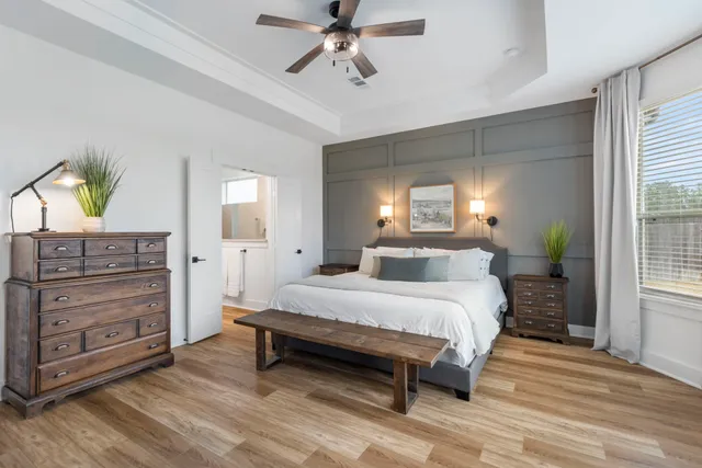 a spacious bedroom with a bed and a dresser