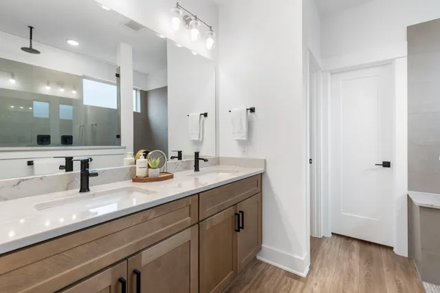 a bathroom with double sink and a mirror