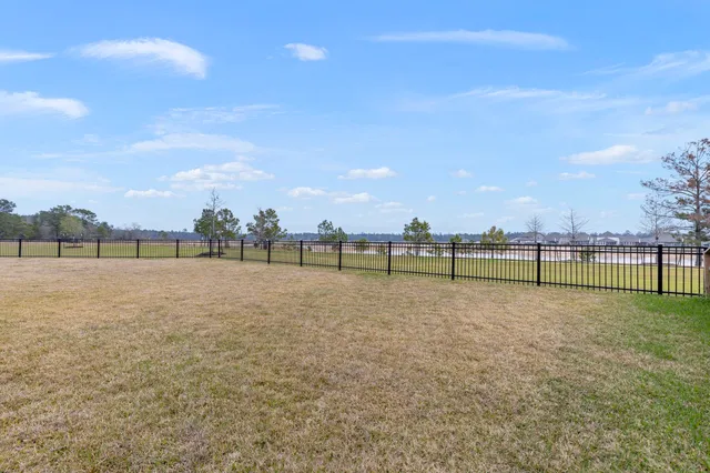 a view of a field with wooden fence