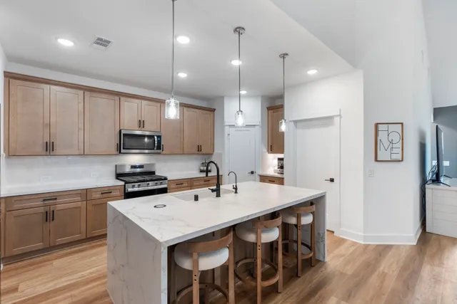 a kitchen that has a table and chairs in it