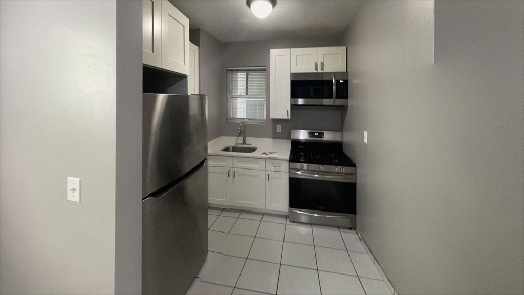 a kitchen with a sink appliances and cabinets
