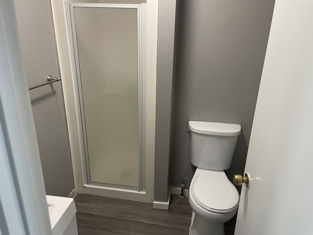 8 Cheever Court, Unit 1 Boston, MA 02128 - Photo 16 of 16 a white toilet sitting next to a shower