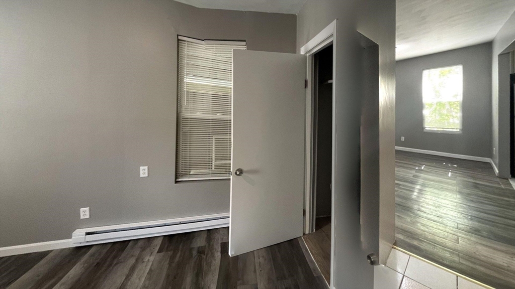 8 Cheever Court, Unit 1 Boston, MA 02128 - Photo 3 of 16 a view of empty room with wooden floor and fan