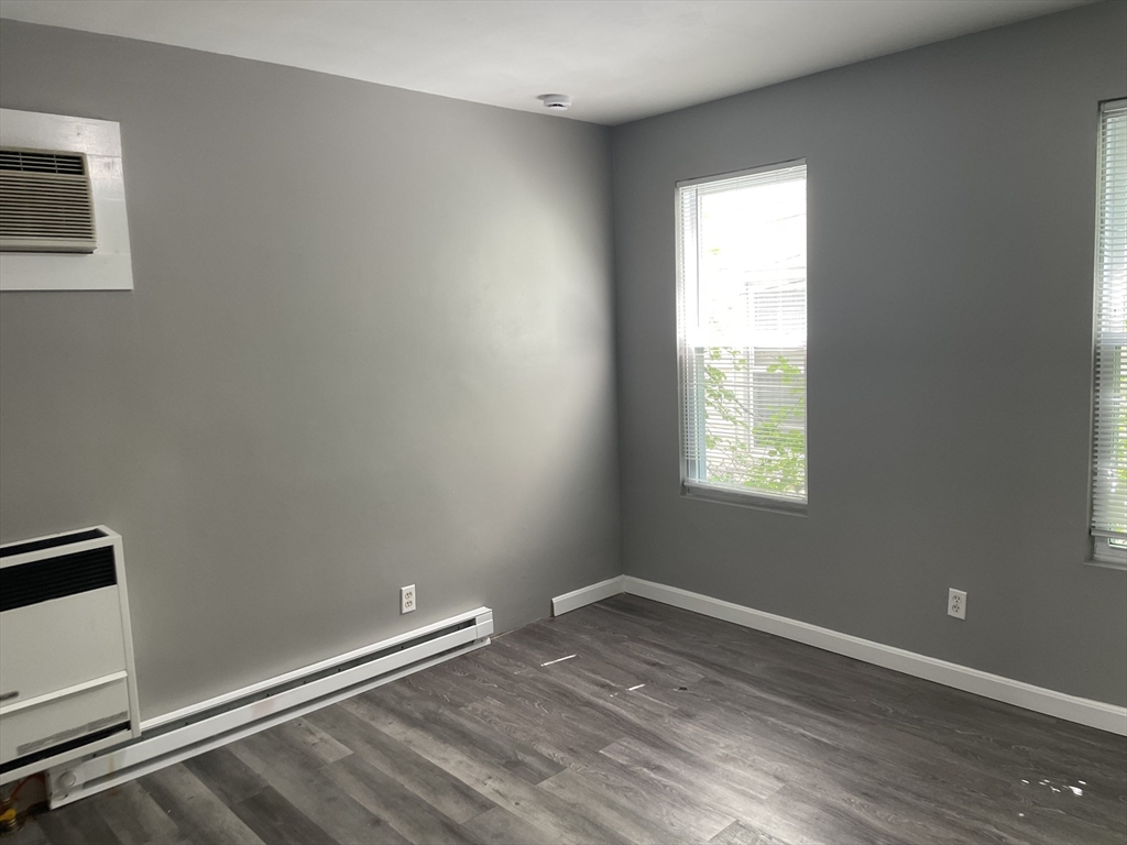 8 Cheever Court, Unit 1 Boston, MA 02128 - Photo 9 of 16 an empty room with wooden floor and windows