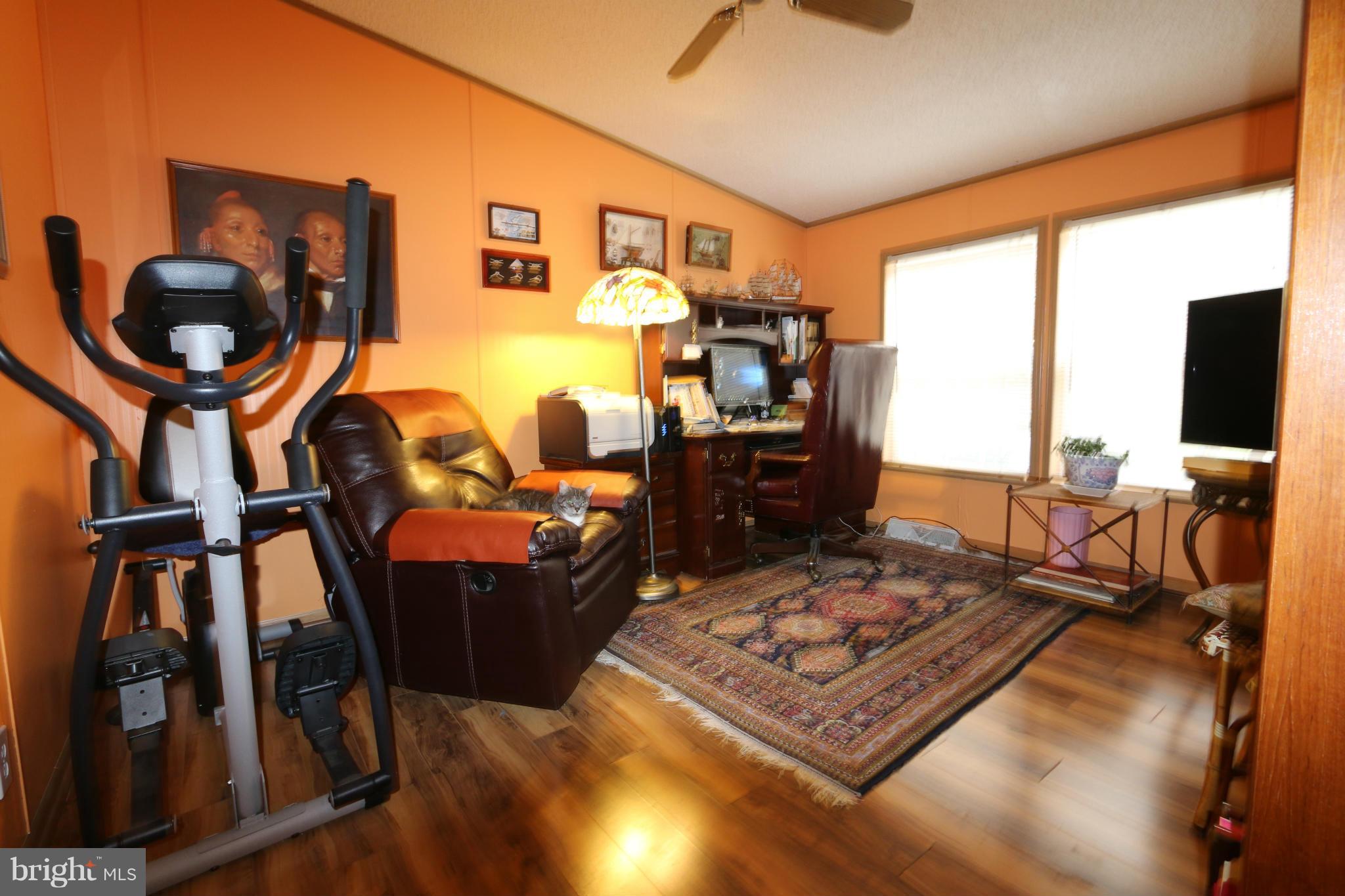 24709 Raven Rock Road Smithsburg, MD 21783 - Photo 13 of 20 a living room with furniture and a flat screen tv