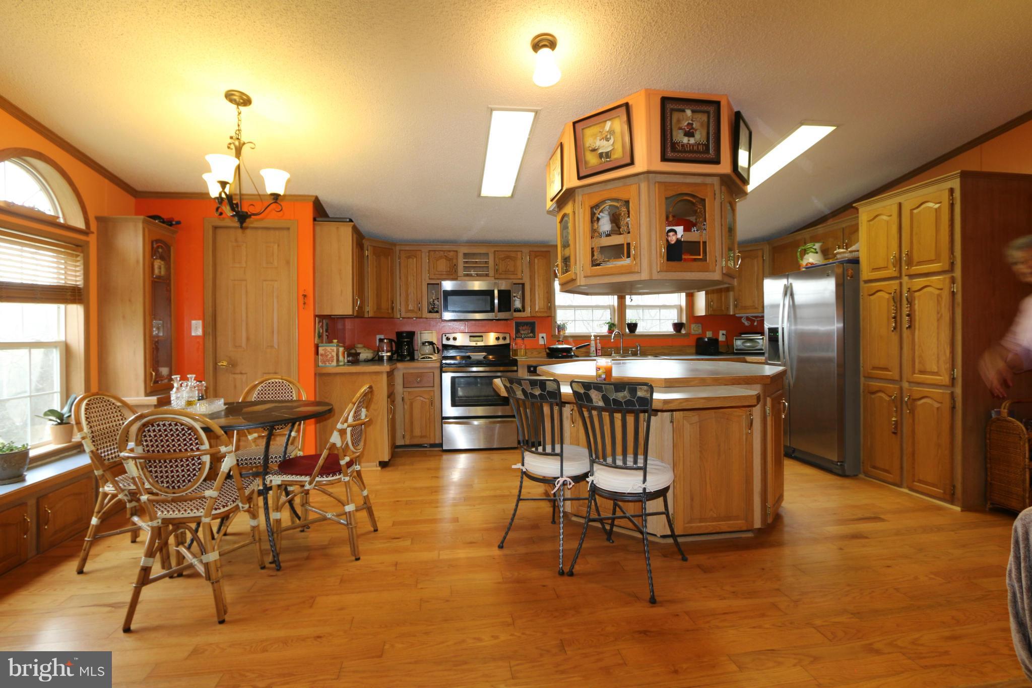 24709 Raven Rock Road Smithsburg, MD 21783 - Photo 3 of 20 a view of a kitchen with furniture and refrigerator